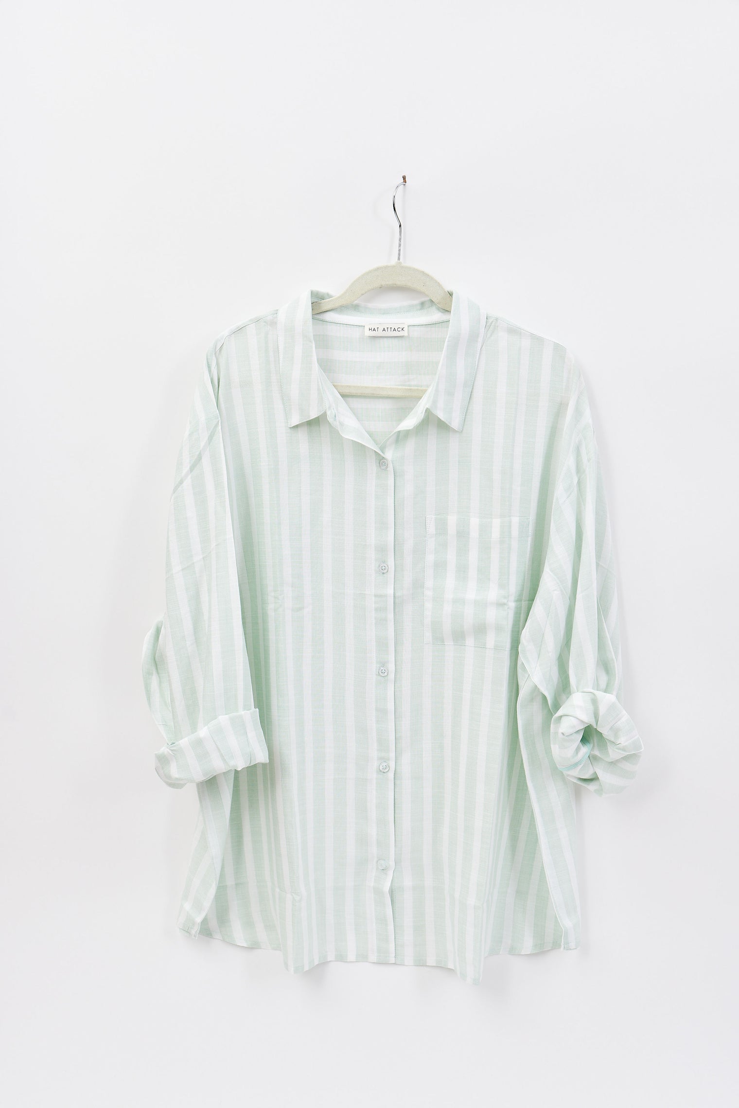 Striped shirt on a hanger against a white background