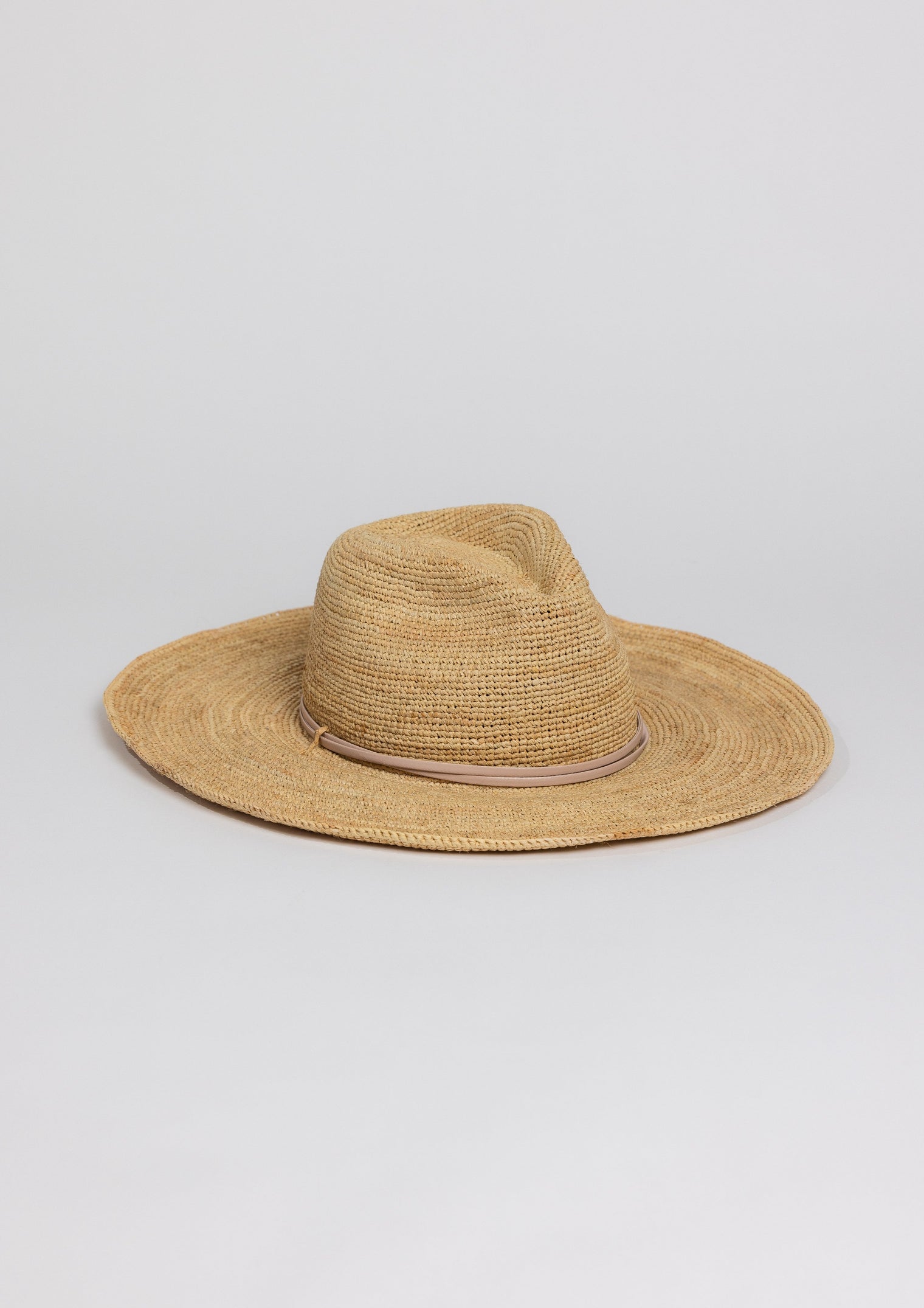 3/4 angle of raffia straw continental sunhat with tan trim detail