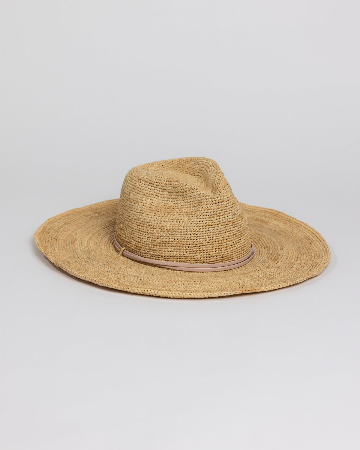 3/4 angle of raffia straw continental sunhat with tan trim detail