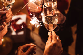 Close up of people holding glass of champagne on New Years eve.