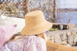 A woman with sun hat facing away from the camera.