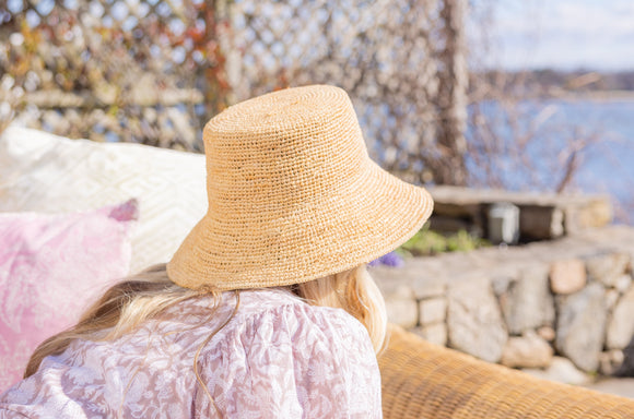 A woman with sun hat facing away from the camera.