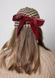 Light checkered hat with red bow on model