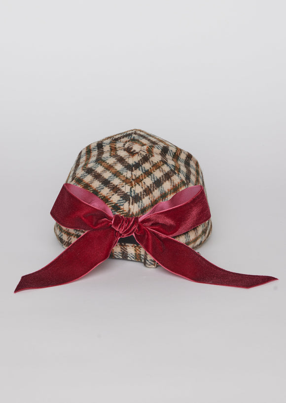 Back of light checkered cap with red bow