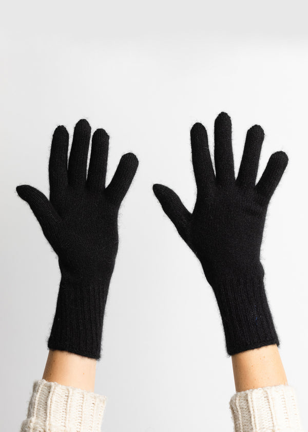 Black cashmere gloves on hands