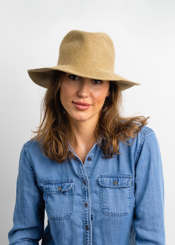 Model wearing camel colored velour hat