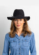 Model wearing a black wool felt brimmed hat and a denim shirt