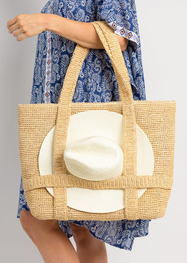 Straw bag with white hat attached with straps