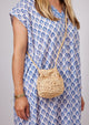 Model wearing small straw pouchette