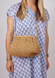 Model wearing brown straw slouchy crossbody bag