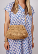 Model wearing brown straw slouchy crossbody bag