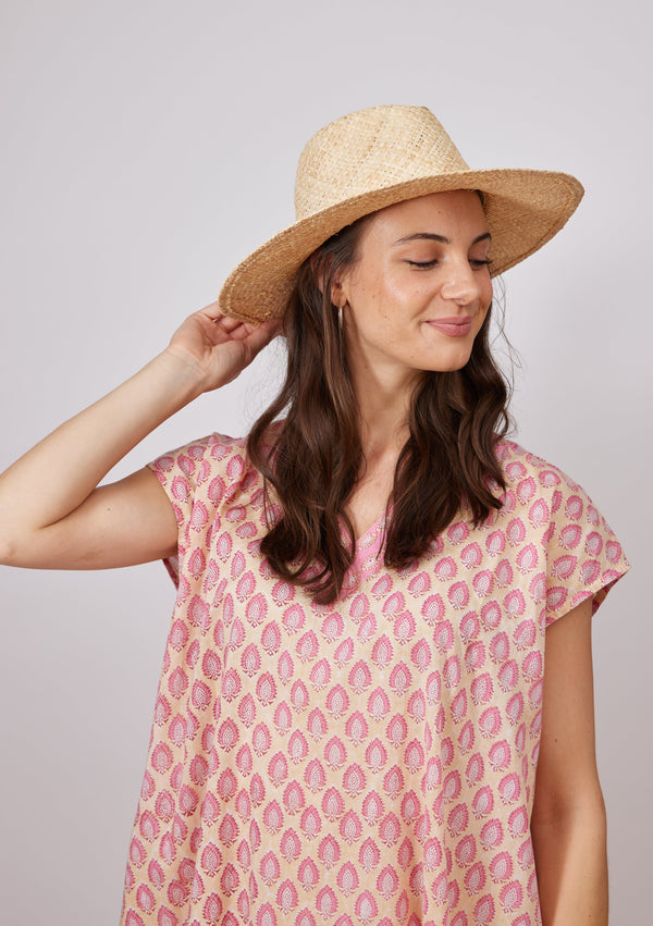 Model holding brim of woven sun hat