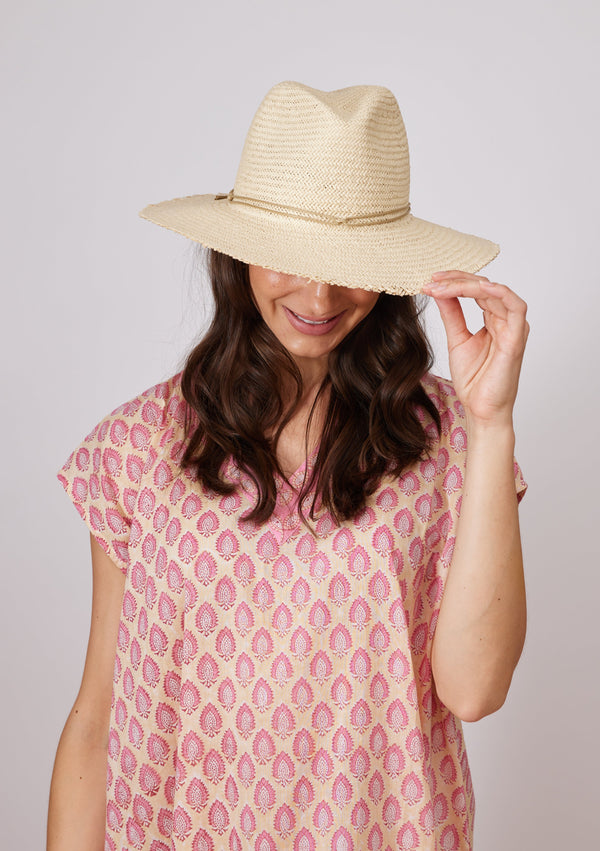 Model wearing straw sun hat with fringed brim