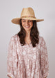 Model wearing straw hat with colorful bead trim