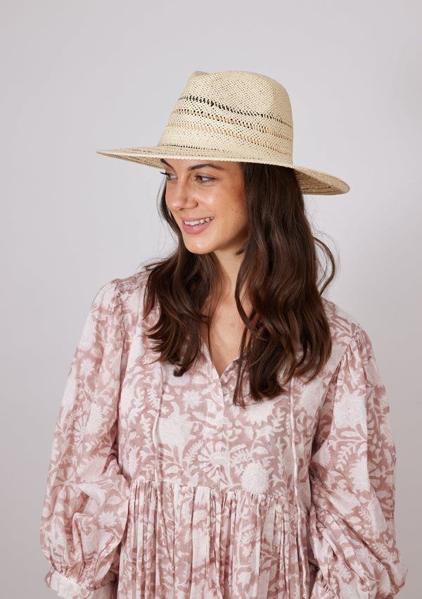 Model wearing striped straw sun hat