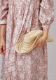 Model holding folded striped sun hat