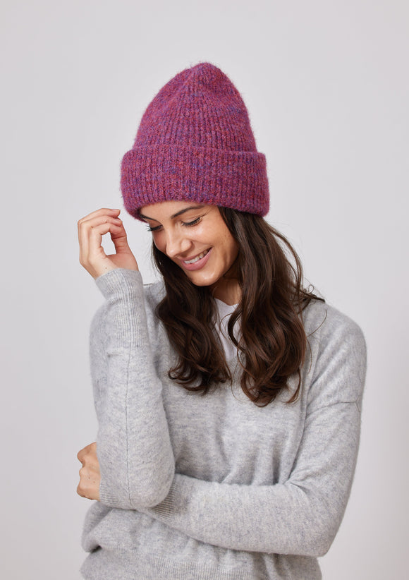 Model wearing raspberry colored cuff beanie