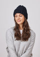 Model wearing black cable knit cuffed beanie