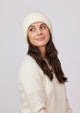 Model looking up while wearing ivory knit cuffed beanie