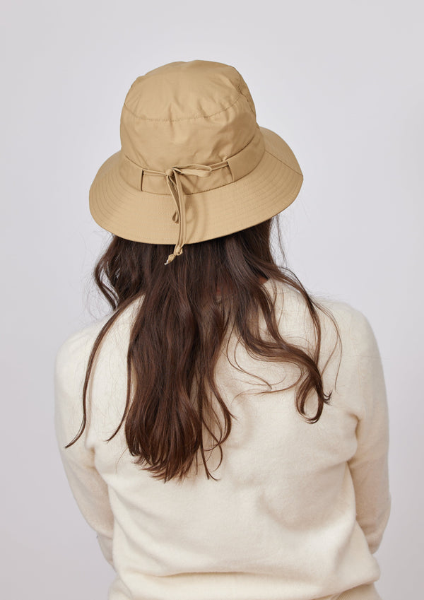 Back of camel brown water resistant bucket hat on model