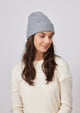 Grey cashmere slouchy cuff beanie on model in ivory sweater