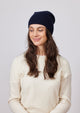 Black slouchy cashmere beanie on model looking to her right