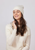 Ivory cashmere slouchy beanie on model in ivory sweater