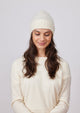 Ivory cashmere slouchy cuff beanie on model looking down