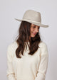 Beige wool felt hat with ivory trim on model in ivory sweater