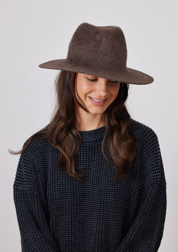 Model wearing brown velour brimmed hat