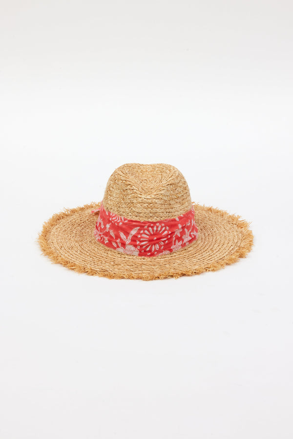 front angle of braided raffia sunhat with coral floral trim