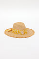 3/4 angle of braided raffia sunhat with yellow floral trim