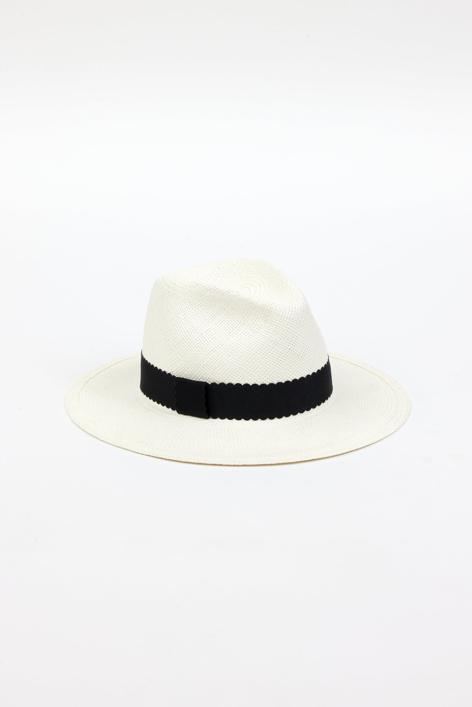 3/4 angle of white straw panama hat with black ribbon trim