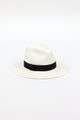 3/4 angle of white straw panama hat with black ribbon trim