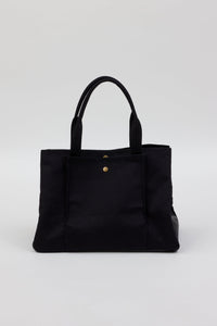 Collapsed black tote with pockets