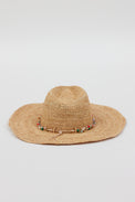 Back of tan straw woven sunhat with multi colored beaded trim