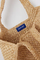 Inside of small structured natural woven straw bag