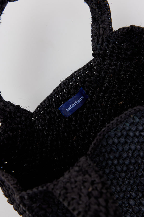 Inside of small structured black woven straw bag