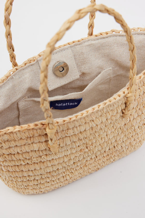Inside of mini straw tote with snap closure