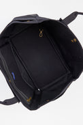 Aerial view of inside of black tote with pockets