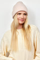 Light pink textured knit cuffed beanie on model