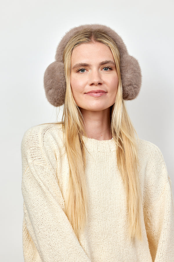 Model wearing taupe faux fur earmuffs