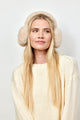 Model wearing natural colored faux fur earmuffs