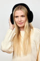 Model wearing black faux fur earmuffs