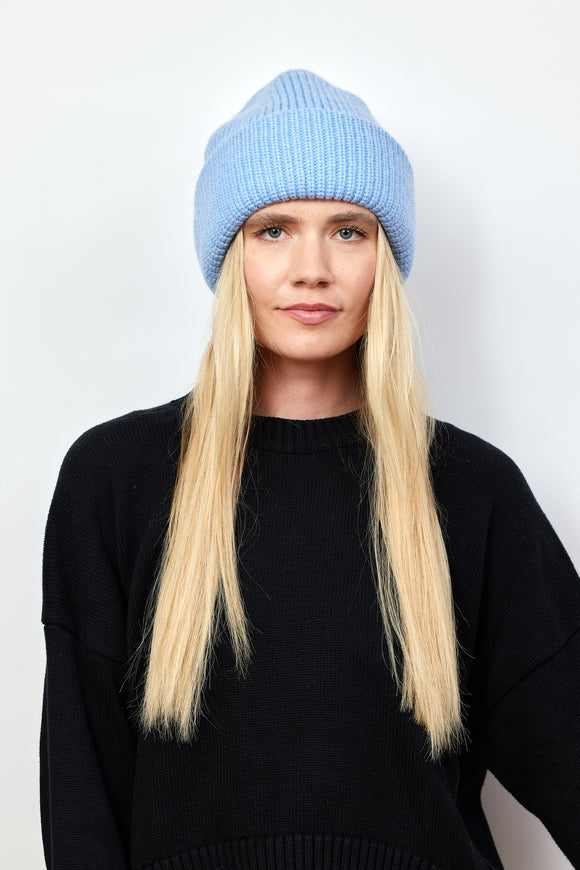 Model wearing light blue knit cuffed beanie