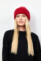 Model wearing red knit cuffed beanie