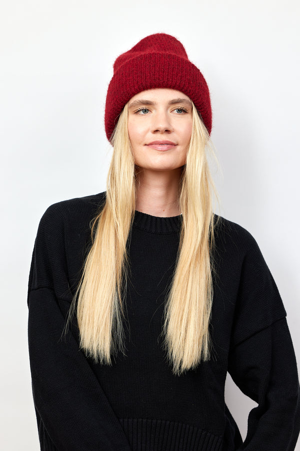 Berry red ribbed knit beanie on model