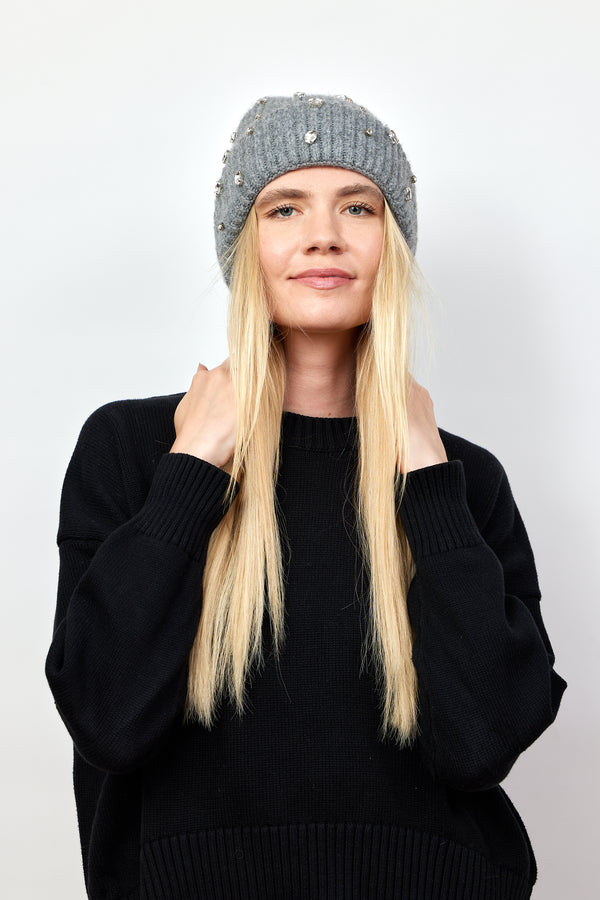 Model wearing grey ribbed beanie with crystal embellishments