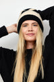 Black and ivory striped ribbed knit cuffed beanie on model