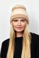 Tan and ivory striped ribbed knit cuffed beanie on model with blonde hair